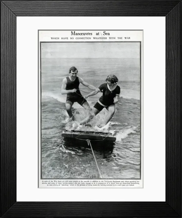 Framed Print : Couple water-planing on a wooden raft