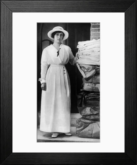 Framed Print : Lady Quilter with pile of comforts for troops, WW1 Framed Print : Lady Quilter with pile of comforts for troops, WW1