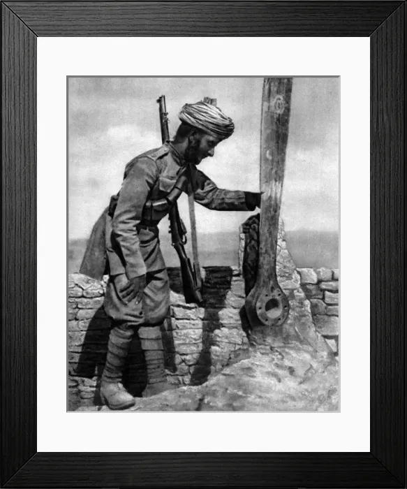 Framed Print : An Indian soldier pays homage to British airmens grave Framed Print : An Indian soldier pays homage to British airmens grave