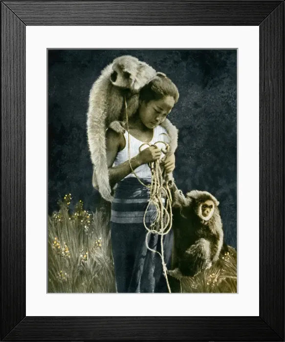 Framed Print : Thai woman accompanied by two gibbons Framed Print : Thai woman accompanied by two gibbons