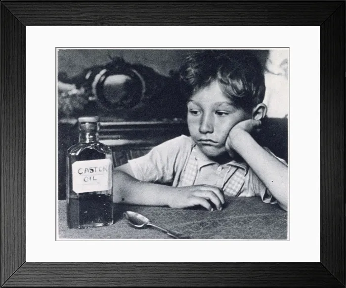 Framed Print : Children were force-fed spoonfuls of castor oil for treatment of constipation. Date: 1939 Framed Print : Children were force-fed spoonfuls of castor oil for treatment of constipation. Date: 1939