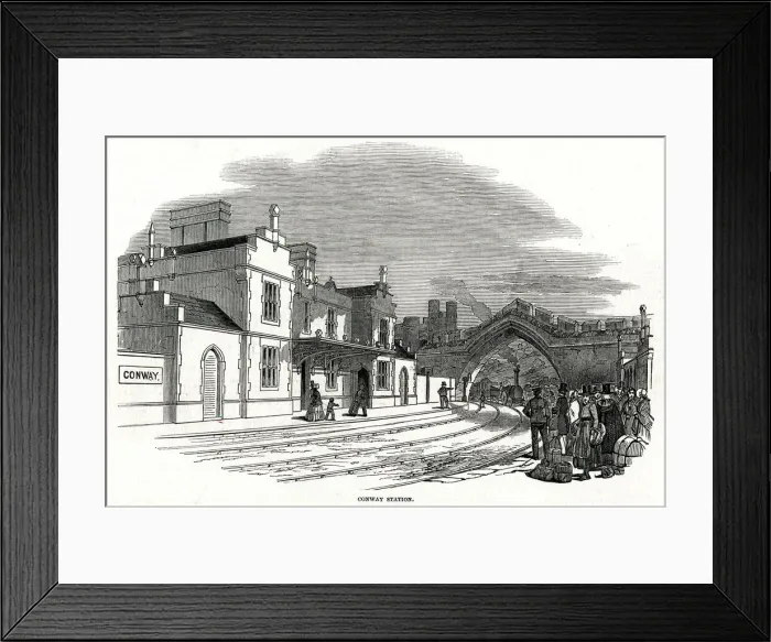 Framed Print : Train passing under arch into Conway railway station 1848