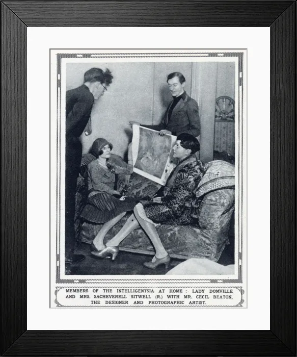 Framed Print : The designer and photographic artist Cecil Beaton (standing - r) showing costume designs to Lady Domville (seated)