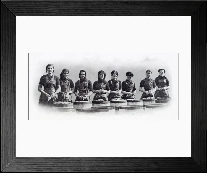 Framed Print : Photograph showing a group of Scottish women standing over the barrels that are being Framed Print : Photograph showing a group of Scottish women standing over the barrels that are being