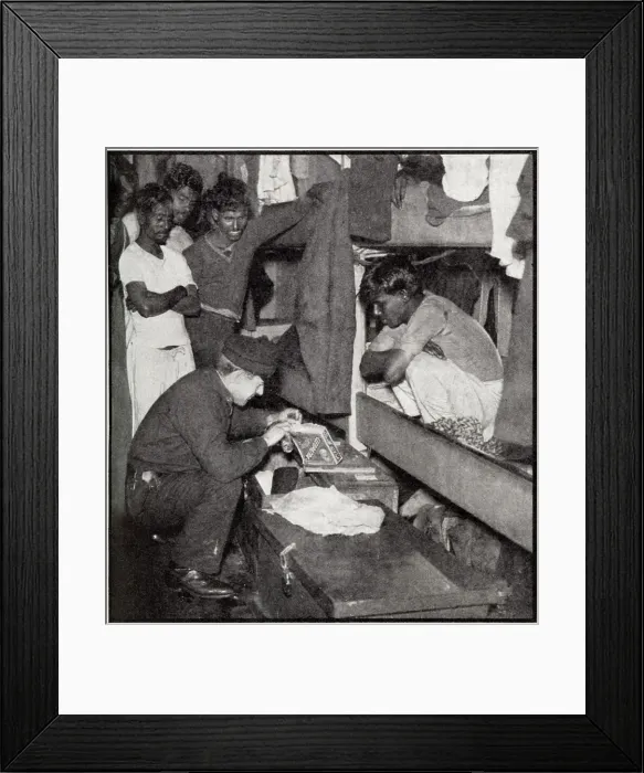 Framed Print : A customs official, torch in hand, searching the Lascar crew's quarters on a sugar freighter in the Thames to make sure that no dutiable goods have been hidden in odd corners Framed Print : A customs official, torch in hand, searching the Lascar crew's quarters on a sugar freighter in the Thames to make sure that no dutiable goods have been hidden in odd corners