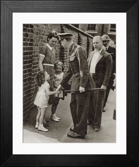 Framed Print : King George VI's visit to the bomb-shattered East End of London in September 1940: shaking hands with the little daughter, Joan Miles, of the caretaker of a school which was bombed. Date: September 1940 Framed Print : King George VI's visit to the bomb-shattered East End of London in September 1940: shaking hands with the little daughter, Joan Miles, of the caretaker of a school which was bombed. Date: September 1940