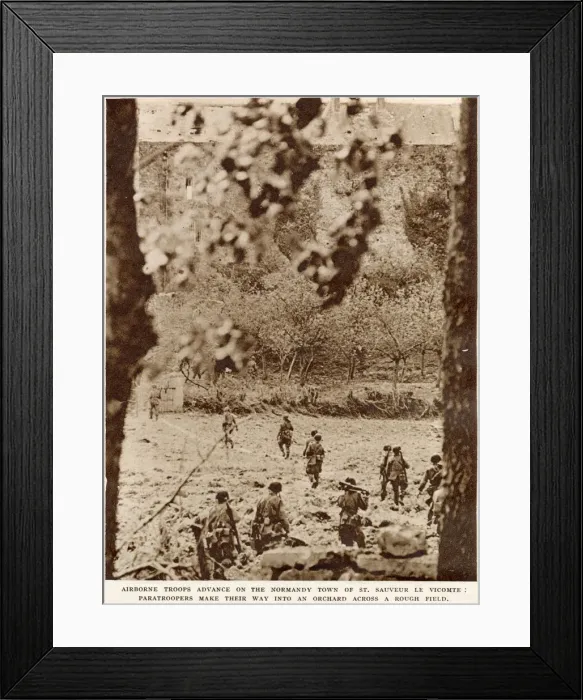 Framed Print : American airborne troops advancing through an orchard to the town of St Framed Print : American airborne troops advancing through an orchard to the town of St