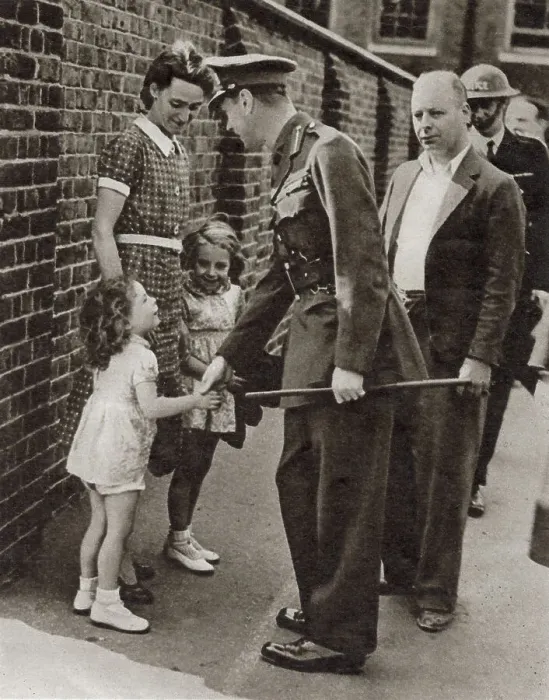 Framed Print : King George VI's visit to the bomb-shattered East End of London in September 1940: shaking hands with the little daughter, Joan Miles, of the caretaker of a school which was bombed. Date: September 1940 Framed Print : King George VI's visit to the bomb-shattered East End of London in September 1940: shaking hands with the little daughter, Joan Miles, of the caretaker of a school which was bombed. Date: September 1940