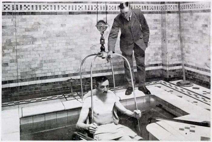 Framed Print : A man been lowered by crain into a bath of hundreds of gallon of radio-active water, for treatment for diseases such as tuberculosis, in Bath, Somerset Framed Print : A man been lowered by crain into a bath of hundreds of gallon of radio-active water, for treatment for diseases such as tuberculosis, in Bath, Somerset