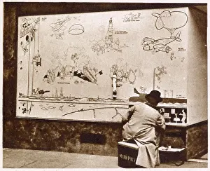 Shops Prints: Artist Norman Keene replicating the original drawings done by William Heath Robinson on boarded up shop fronts