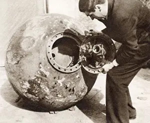 1937 Prints: A Basque soldier taking apart a Nationalist mine (sea mine) in Bilbao