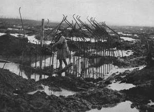 Landscape Prints: British soldier examing framework of pill-box, WW1