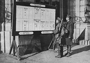 Stations Prints: British soldiers looking at German timetable in Mons station