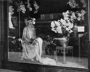 Bouquet Prints: Debutante poses in a shop window, 1928