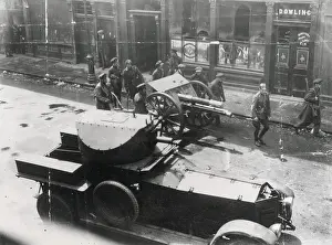 Dublin Prints: Easter Rising, 1916. Soldiers with gun and armoured car in the streets of Dublin outside Dowling or Dowling's pub