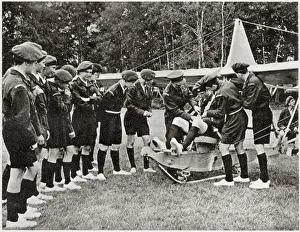 Public Prints: Flt.Lieut. Wilson helping to adjust the equipment of the pilot as one of the boys prepares to take off in a glider