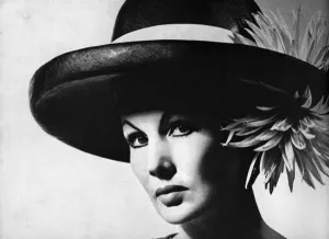 Prints of Ex-model Barbara Goalen (then Mrs Nigel Campbell) wearing a large navy straw hat with a big brim and high crown by James Wedge for Liberty. Date: 1962 August Prints: Hat by Sybella, 1962