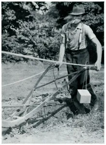 Labor Prints: Man ploughing with gas mask, September 1939