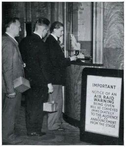 Cinema Prints: Three men at the cinema with their gas masks, September 1939