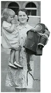 Infants Prints: Mother holding baby and specialised gas mask, Sept 1939