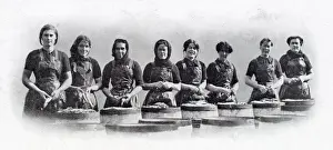 Group Prints: Photograph showing a group of Scottish women standing over the barrels that are being