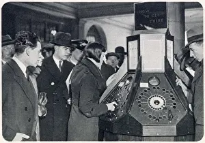 Route Prints: Photograph showing a queue of passengers waiting to use the new mechanical informator at Charing Cross Underground