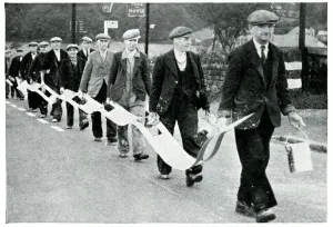Drive Prints: Road painters carrying broken white line stencil, Sept 1939