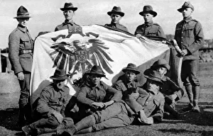 Posed Prints: Soldiers from the New Zealand Expeditionary Force posed with the captured Imperial German Standard