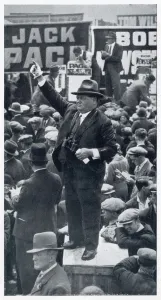 Sport Prints: A tic-tac man at work on a soap box on Epsom Downs racecourse. Date: 1937