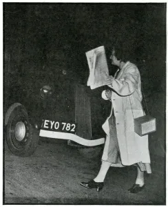 Pedestrian Prints: Woman crossing road in the dark in white coat, Sept 1939