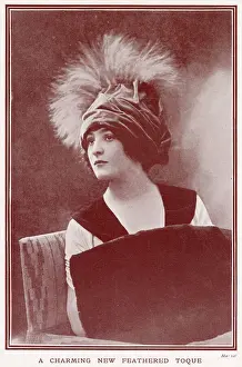 Feathered Prints: Woman wearing a fashionable velvettoque hat with plumes of feathers. Date: 1911