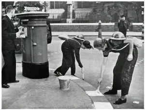 Precautions Prints: Women painting kerbside for blackouts, September 1939