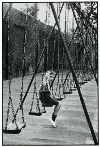 Park Prints: Young boy alone on a playground swing 1939