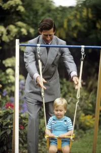 Princes Prints: Young Prince william on a swing, pushed by Prince Charles